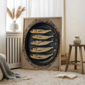 May include: A framed print of a vintage illustration of a plate of sardines. The plate is blue and white with a decorative border. The sardines are arranged in a circle and are depicted in a realistic style.
