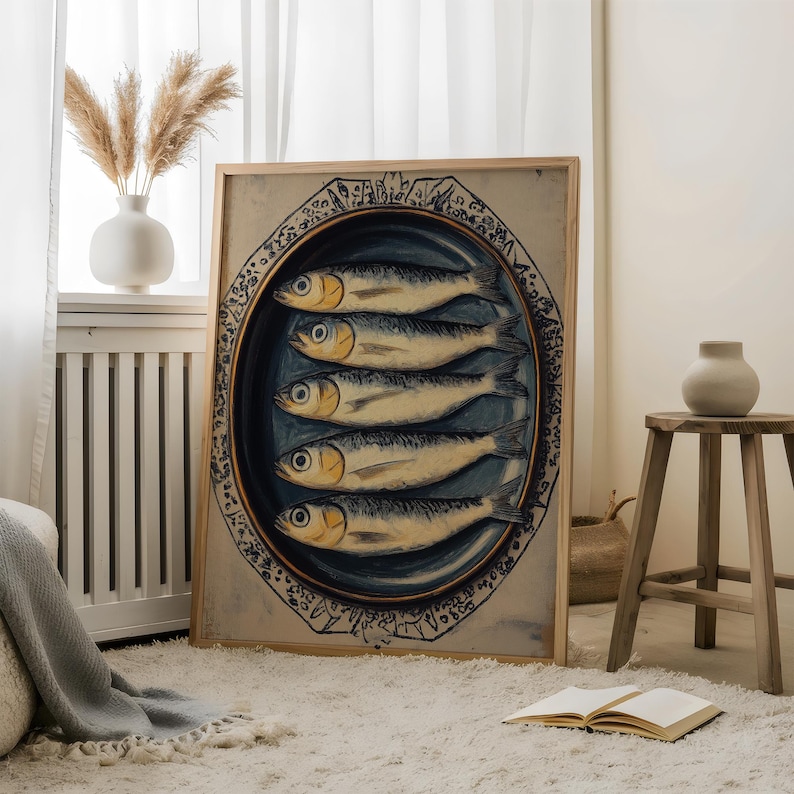 May include: A framed print of a vintage illustration of a plate of sardines. The plate is blue and white with a decorative border. The sardines are arranged in a circle and are depicted in a realistic style.