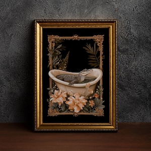 May include: A framed art print depicting an alligator in a bathtub. The artwork is set against a black background and framed with a gold ornate frame. Peach-coloured flowers and green foliage surround the tub.