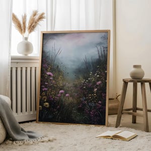May include: A framed print of a misty forest scene with a path leading through a field of purple and yellow wildflowers.
