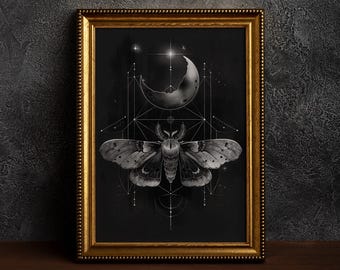 May include: Black and white framed art print featuring a moth with geometric designs, a crescent moon, and stars. The artwork is set against a dark background and framed in a gold-colored frame.