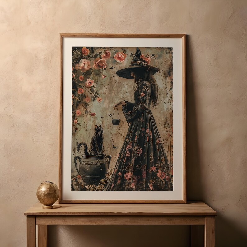 May include: A framed print of a witch in a black dress and a pointed hat, standing with a black cat in a cauldron, surrounded by pink roses.