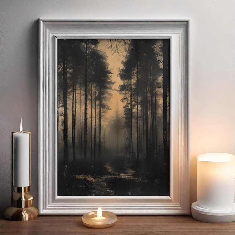 May include: A framed print of a foggy forest scene with tall trees and a path leading into the distance. The sky is a soft orange color, and the trees are silhouetted against the light.