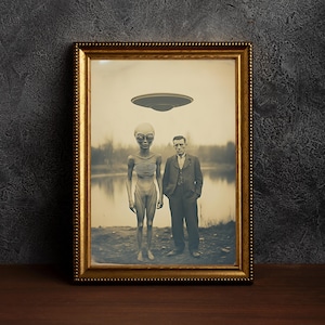 May include: A black and white photograph in a gold frame shows a man standing next to a gray alien. The alien is wearing a large, round head with large eyes. The man is wearing a suit and tie. A flying saucer is hovering above them.