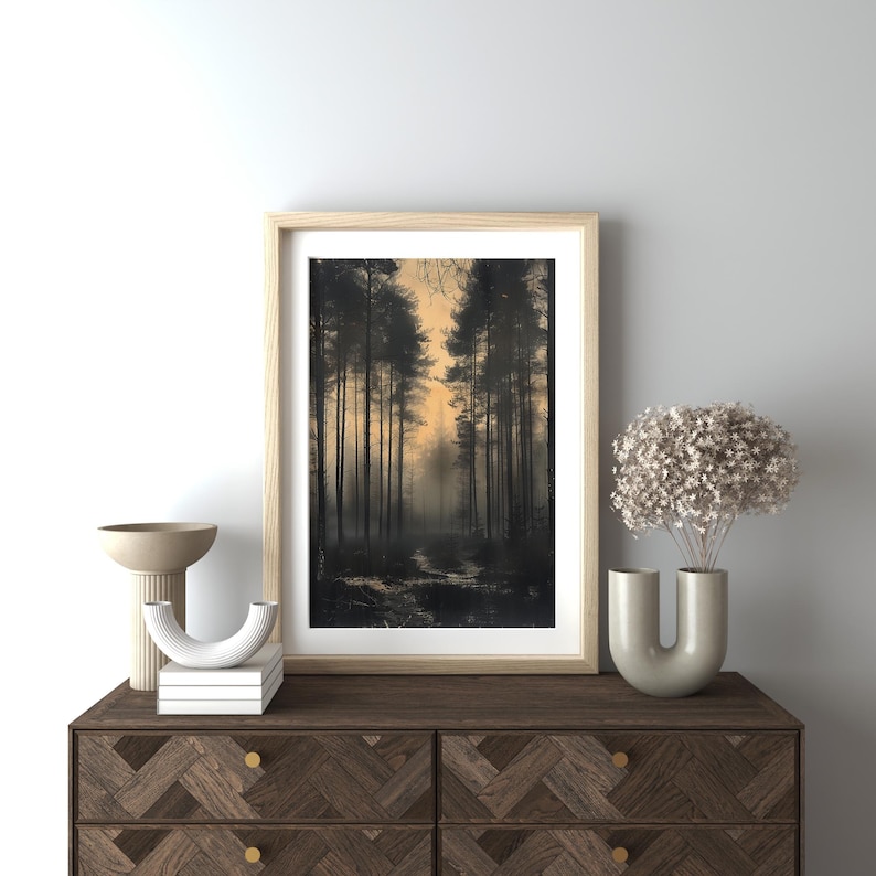 May include: A framed photograph of a forest path lined with tall trees, with a soft, golden light filtering through the branches. The trees are silhouetted against the light, creating a sense of mystery and depth.
