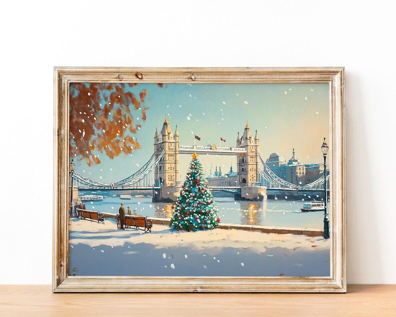 May include: A painting of the Tower Bridge in London with a Christmas tree in the foreground. The bridge is decorated with lights and there is snow falling. The painting is framed in a light wood frame.