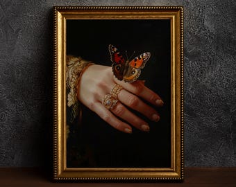 May include: A painting in a gold frame depicts a hand with a butterfly perched on a finger. The hand is wearing a ring with a large, sparkling gemstone.