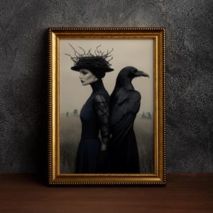 May include: A framed print depicting a woman in a black dress and a raven standing back-to-back in a field. The woman wears a hat with twig-like details. The frame is gold, and the background is a dark, textured wall.