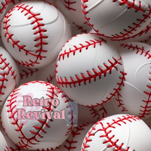 May include: A close-up of a pile of white baseballs with red stitching. The baseballs are arranged in a random pattern, with some of them overlapping.
