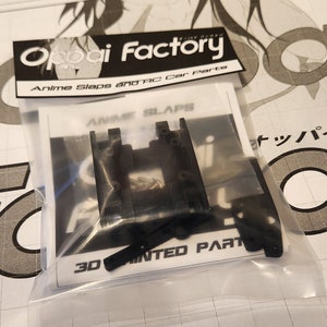 K&ouml;nnte beinhalten: Eine transparente Plastikt&uuml;te mit schwarzen 3D-gedruckten Autoteilen, die mit "Anime Slaps" und "3D Printed Parts" beschriftet sind. Die T&uuml;te ist mit "Oppai Factory Anime Slaps and RC Car Parts" beschriftet.