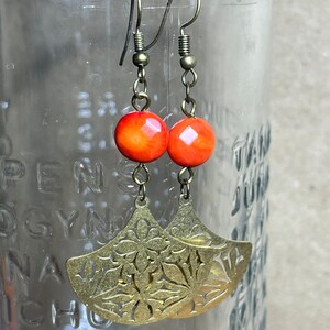 Dyed authentic Coral and brass charm earrings.