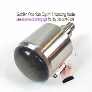 May include: A silver metal tuning grip with a black obsidian crystal node. The text "en∞Tune Harmony Tuning Grip Required" is visible at the bottom of the image.