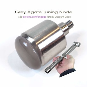 May include: Grey agate crystal tuning node with a silver metal base and a silver metal tuning fork. The tuning fork is labeled "en Tune". See en-tune.com/engage for Etsy Discount Code.