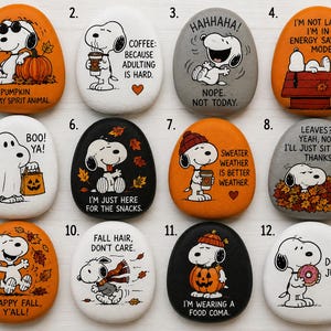 Peut inclure: Douze pierres ovales et lisses peintes avec diverses illustrations de Snoopy et du texte. Chaque pierre présente une scène unique, incluant des citrouilles, des feuilles d'automne, du café et des phrases humoristiques comme 'Pumpkin is my spirit animal'.