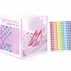May include: A clear acrylic 10K Hustle Box with a slot on top, featuring a pink high-heeled shoe design. The box has a grid for tracking savings and includes heart-shaped stickers. The text "10K Hustle Box $10,000" is visible on the front.
