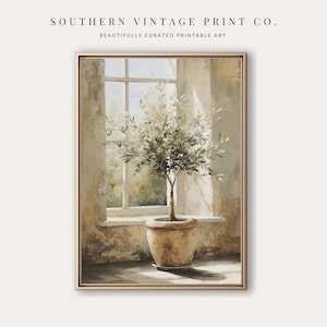 May include: A framed print featuring an olive tree in a terracotta pot, set against a sunlit window. The artwork has a neutral color palette with the text "SOUTHERN VINTAGE PRINT CO." and "BEAUTIFULLY CURATED PRINTABLE ART" at the top.