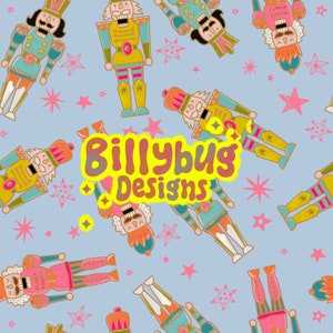 May include: A repeating pattern of colorful nutcracker figures and pink stars on a light blue background. The text "Billybug Designs" is in a yellow bubble. The nutcrackers are in various colors, including pink, gold, and teal.