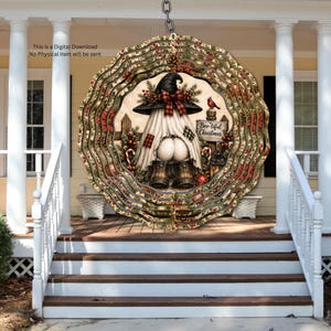 May include: A circular wind spinner featuring a gnome wearing a witch hat and boots, with a white sheet draped over its body. The design includes a sign reading Boo-tiful Christmas, red berries, pine branches, and a cardinal bird on a fence.