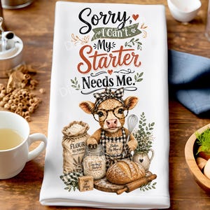 Puede incluir: Un paño de cocina blanco con el gráfico de un ternero que lleva una diadema de cuadros blancos y negros y gafas, con el texto Sorry, I Can't. My Starter Needs Me. El diseño incluye un saco de harina, un tarro y pan.