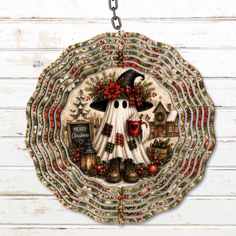 May include: A circular metal wind spinner featuring a ghost wearing a witch hat, boots, and a plaid-patched sheet. The ghost holds a red mug with a heart, standing near a sign that reads Merry Christmas, a lantern, and a snowy house.