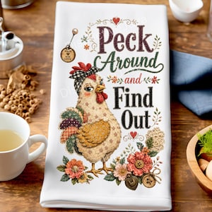 May include: A white kitchen towel featuring a graphic of a chicken wearing a black and white checkered bow, surrounded by floral elements and buttons. The text reads, "Peck Around and Find Out," with a small "Made with Love" tag illustration.