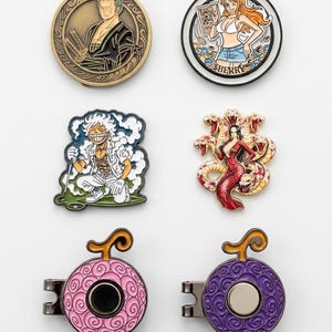 May include: A collection of six metal enamel pins featuring anime characters and fruit-shaped designs. The set includes circular character portraits, a crouching figure in smoke, a snake-themed character, and two round fruit pins in pink and purple.