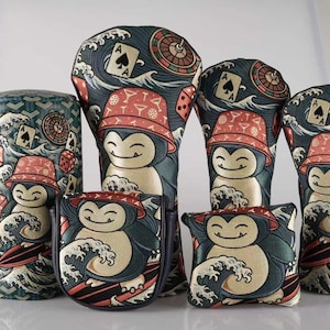 May include: A collection of six golf club head covers featuring a cartoon character wearing a bucket hat, surfing on a wave, with casino-themed icons like playing cards, dice, and roulette wheels printed on a dark teal background with wave patterns.