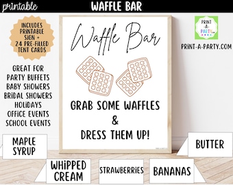 May include: A framed sign with the words "Waffle Bar" and waffle illustrations. The sign includes text about party buffets, baby showers, and holidays. Below are labels for toppings like maple syrup, whipped cream, strawberries, bananas, and butter.