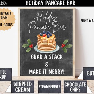 May include: A printable Holiday Pancake Bar sign with a chalkboard background, featuring a stack of pancakes topped with berries and syrup, holly sprigs, and the text: Holiday Pancake Bar, Grab a stack & make it merry! Includes matching tent cards.