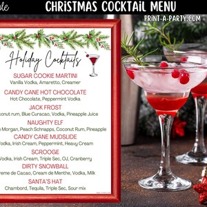 May include: A rectangular Christmas cocktail menu sign with a red frame, featuring a green pine and holly border, the text "Holiday Cocktails," and a list of seven drink recipes including Sugar Cookie Martini and Santa's Hat, next to two cocktails.
