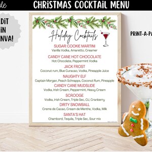 May include: A Christmas cocktail menu sign featuring a pine and holly border, the text Holiday Cocktails, and a list of seven drink names with ingredients. Beside the sign is a martini glass with a rim of brown crumbs and a gingerbread man cookie.