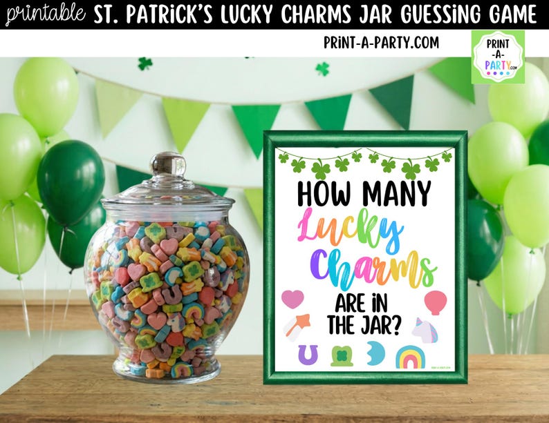 May include: A clear glass jar filled with colorful Lucky Charms cereal, next to a framed sign that reads "How Many Lucky Charms Are In The Jar?" The sign is green with rainbow text and St. Patrick's Day themed graphics. Green balloons and a banner are in the background.