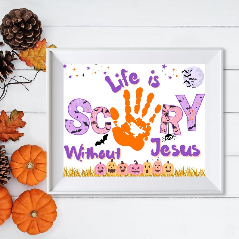May include: A white framed print featuring the text Life is Scary Without Jesus in purple and pink lettering. The letter A is replaced by an orange handprint. The design includes a full moon with bats, a spider, and a row of small pumpkins.