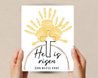 May include: A white card with a yellow handprint design depicting a cross. The text reads "He is risen" and "God bless you!"