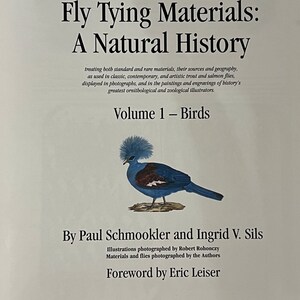 May include: Book cover with the title "Rare and Unusual Fly Tying Materials: A Natural History, Volume 1 - Birds" by Paul Schmookler and Ingrid V. Sils. The cover features an illustration of a blue bird with a crest.