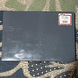 May include: A gray metal box with a label that reads "Pico PRRT-0004-T Solderless Terminal Kit". The box is rectangular and has a slightly scratched surface. The label is white with red borders and black text.