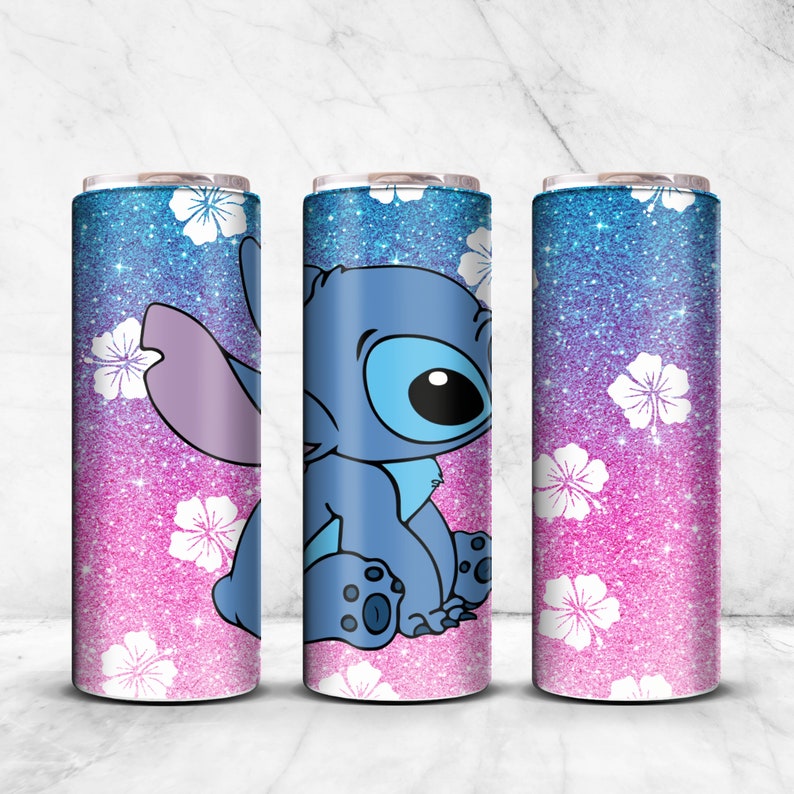 May include: Three stainless steel tumblers with a pink and blue glitter background and white flowers. The center tumbler features a blue cartoon character, Stitch, from the Disney movie Lilo & Stitch.