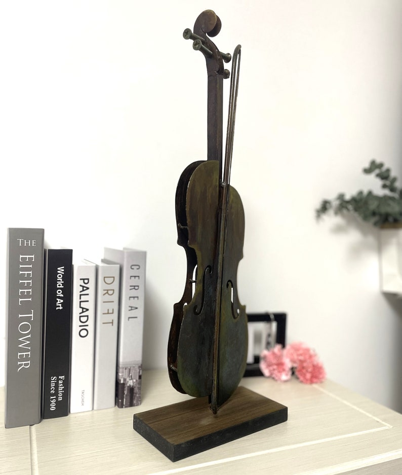 This is 3D metal violin sculpture.Sutable stand on the desk with perfect size. 100% handmade art. Meterial in iron and acrylic pigment .it is good idea for home decor.