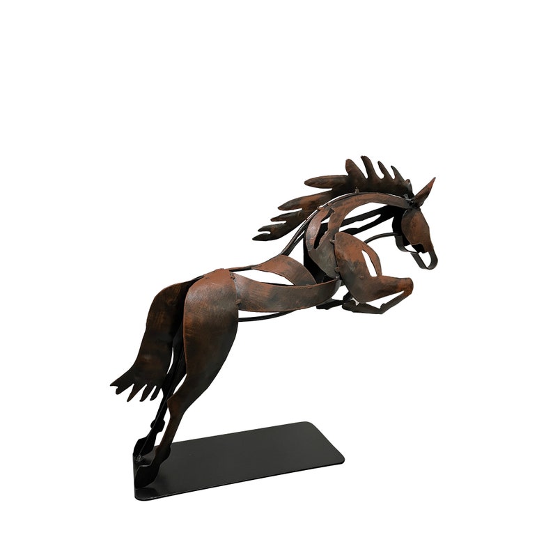 May include: A rusty brown metal sculpture of a horse leaping into the air. The horse is on a black metal base.