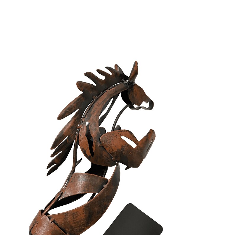 May include: A rusty brown metal horse sculpture with a stylized design. The horse is standing on a black base.