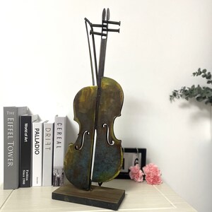 This is 3D handmade Violin figurine. Sutable stand on the table with perfect size. In rustic color with blue, golden, black and brown. Meterial in Iron and acrylic pigment .it is good idea for home and office decor.