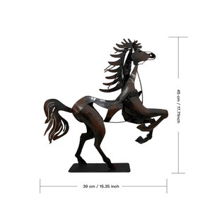 May include: A black metal horse sculpture with a detailed mane and tail. The horse is standing on its hind legs with its front legs raised. The sculpture is 17.71 inches tall and 15.35 inches wide.