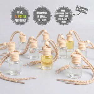 May include: A collection of small, clear glass bottles with wooden lids and beige cords. Some bottles contain a yellow liquid. The image includes text that reads "8 ML 15 BOTTLE PER ORDER", "HANDMADE IN SMALL BATCHES", and "FREE EDITABLE CANVA TEMPLATE FOR CANDLE LABEL".