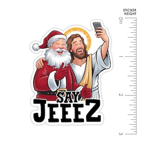 May include: A sticker showing Santa Claus and Jesus taking a selfie. Santa wears a red suit and hat, Jesus is in white robes. The text "SAY JEEZ" is below. The sticker is approximately 5 cm tall.