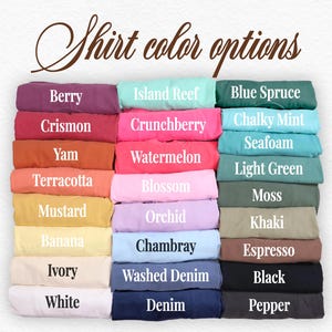 May include: A chart of 24 different t-shirt colors, with each color displayed as a folded t-shirt. The colors are: Berry, Crismon, Yam, Terracotta, Mustard, Banana, Ivory, White, Island Reef, Crunchberry, Watermelon, Blossom, Orchid, Chambray, Washed Denim, Denim, Blue Spruce, Chalky Mint, Seafoam, Light Green, Moss, Khaki, Espresso, Black, and Pepper.