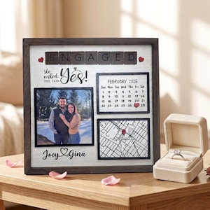 May include: A set of three ceramic mugs with a speckled, cream-colored glaze. Each mug features a different hand-painted design: a blue and green leaf, a yellow and orange flower, and a red and pink berry. The mugs have a simple, rounded shape.