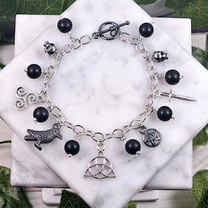 The Morrigan charm bracelet, celtic goddess, devotional jewelry, witchy gift, raven, pagan, wiccan, skulls