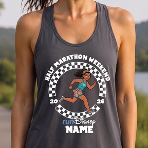 May include: A charcoal gray racerback tank top featuring a graphic of a running character inside a black and white checkered circle. The text reads HALF MARATHON WEEKEND 2026, runDisney, and NAME. The design includes a runner wearing a teal top.