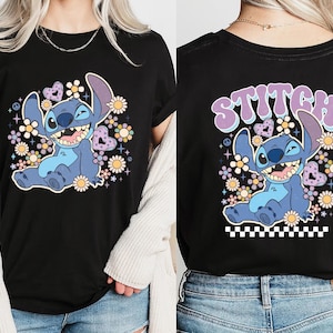 a woman wearing a black shirt with a stitch stitch stitch stitch stitch stitch stitch stitch