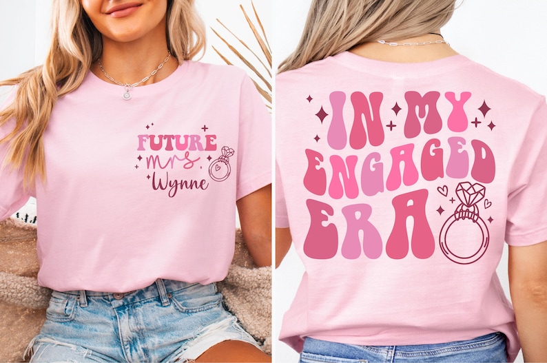 May include: Pink t-shirt with the text "Future Mrs. Wynne" and a ring on the front. The back of the shirt has the text "In My Engaged Era" in a retro font with a ring.